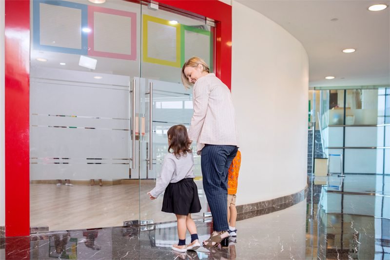 Adult and child entering a colorful room